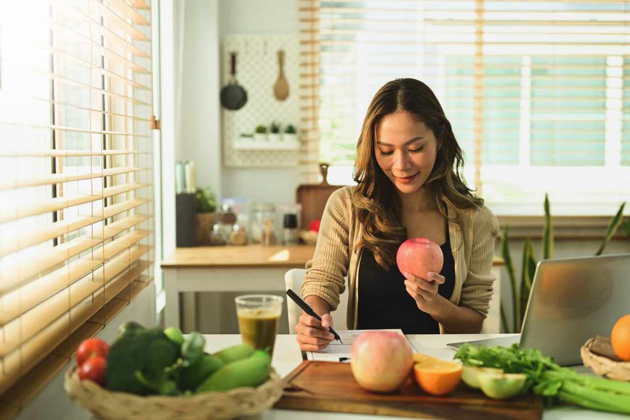 nutritionist woman woking with fruits at her desk